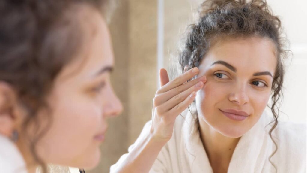 femme creme visage yeux regarde miroir